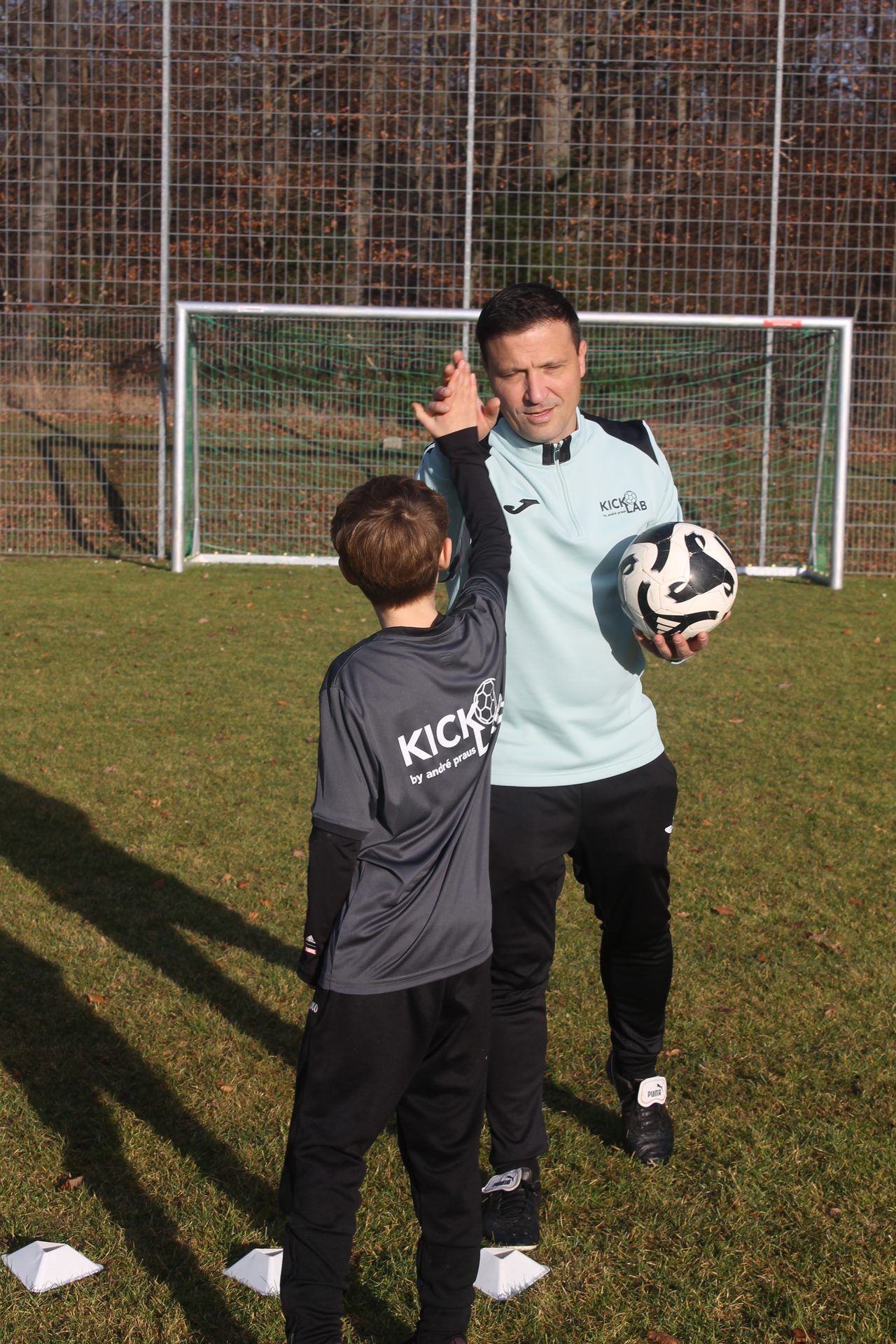 Trainer und Kind nah am Ball – KickLab Fußballtraining Eisingen